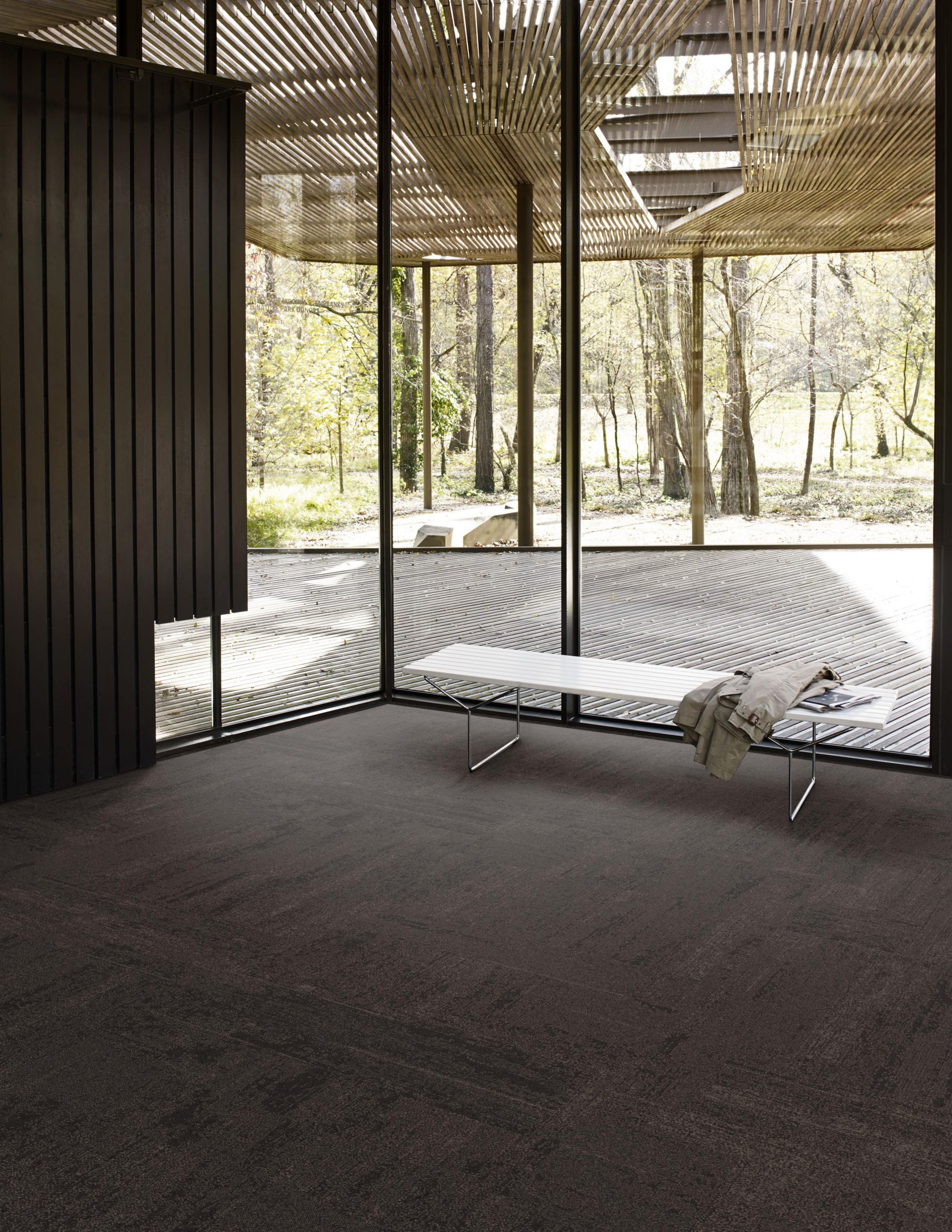 Interface LC01 carpet tile in recreation area with glass walls and wood tones image number 2